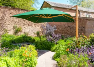 green cantilever parasol with a wood effect frame in lush garden