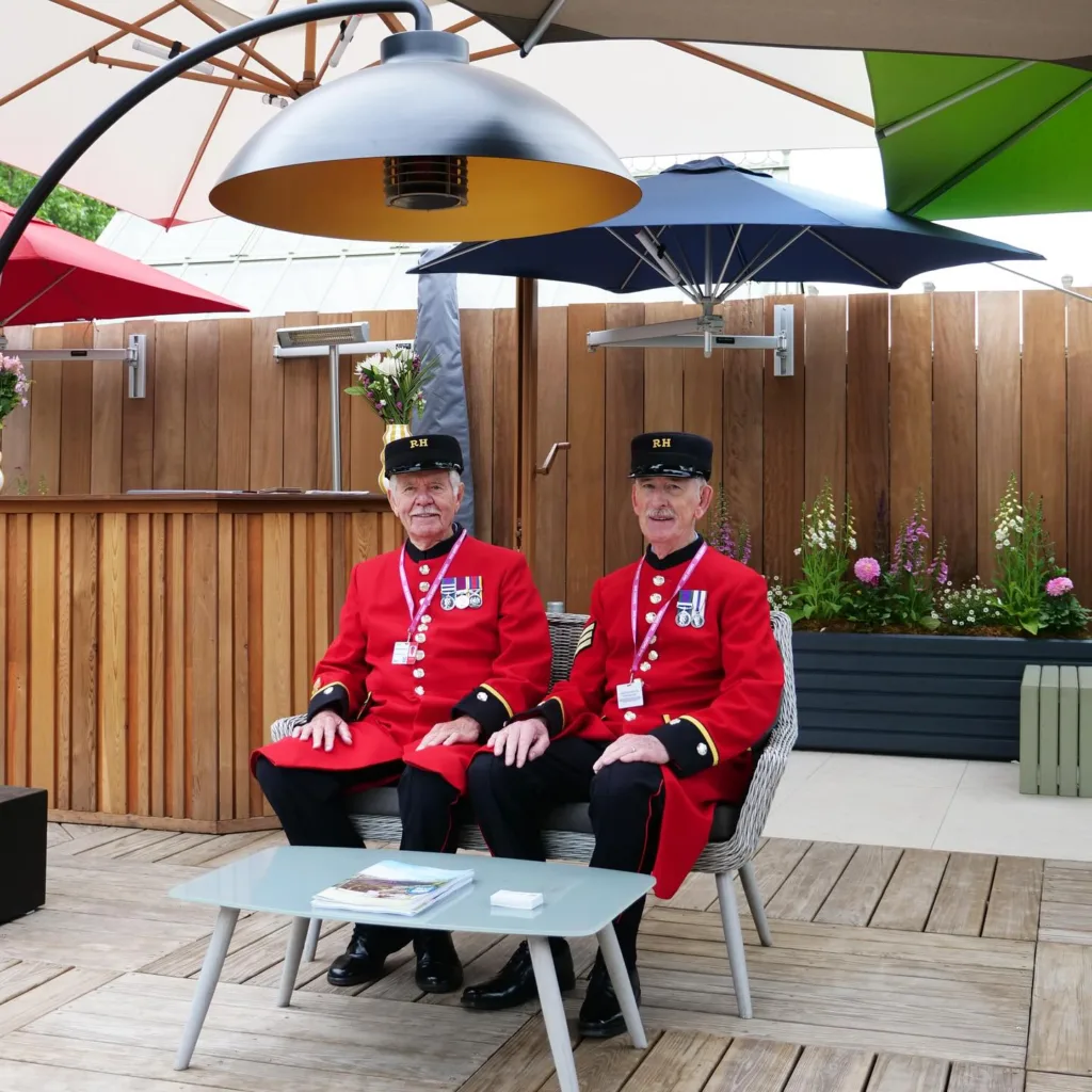 Chelsea Pensioners sat at the Instashade trade show stand at RHS Chelsea Flower Show