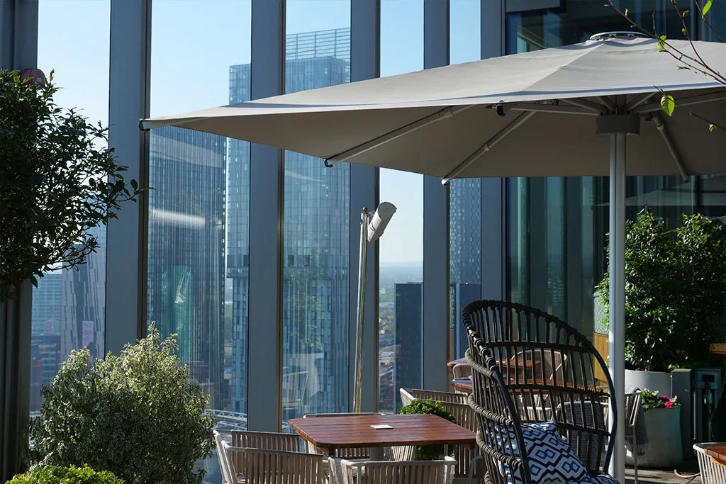 Sleek minimalist Instashade commercial parasol on the outdoor rooftop luxury terrace at 20 Stories Manchester.